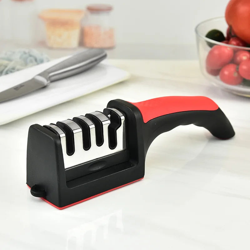 Knife sharpener with red handle on a white surface