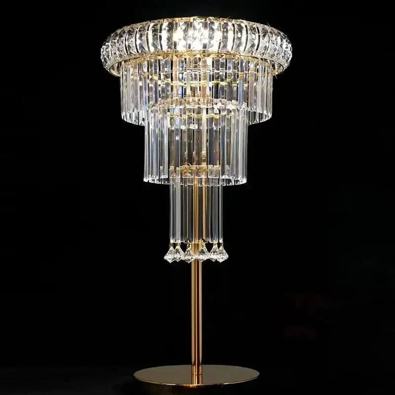 Decorative crystal lamp with gold base on a black background