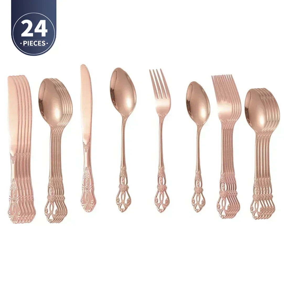 Rose gold flatware set with knife, fork, and spoons on a white background