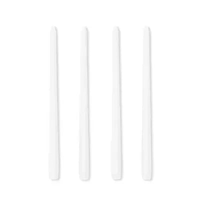 Four white candles on a white background