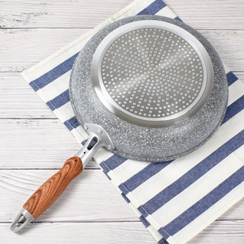 Frying pan with wooden handle on a striped cloth