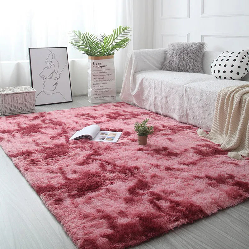 Living room with a pink rug, white sofa, and decorative items.