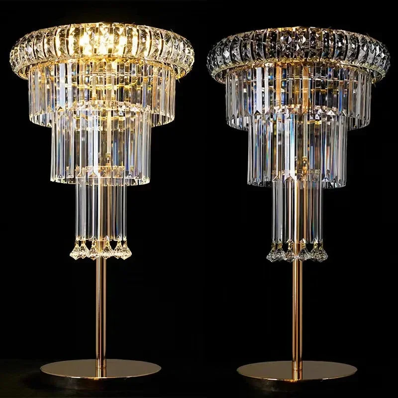 Two crystal table lamps with gold bases on a black background