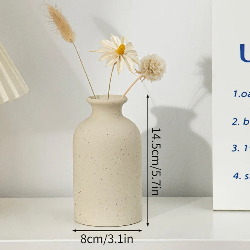 White ceramic vase with dimensions: 8cm diameter base, 14.5cm height
