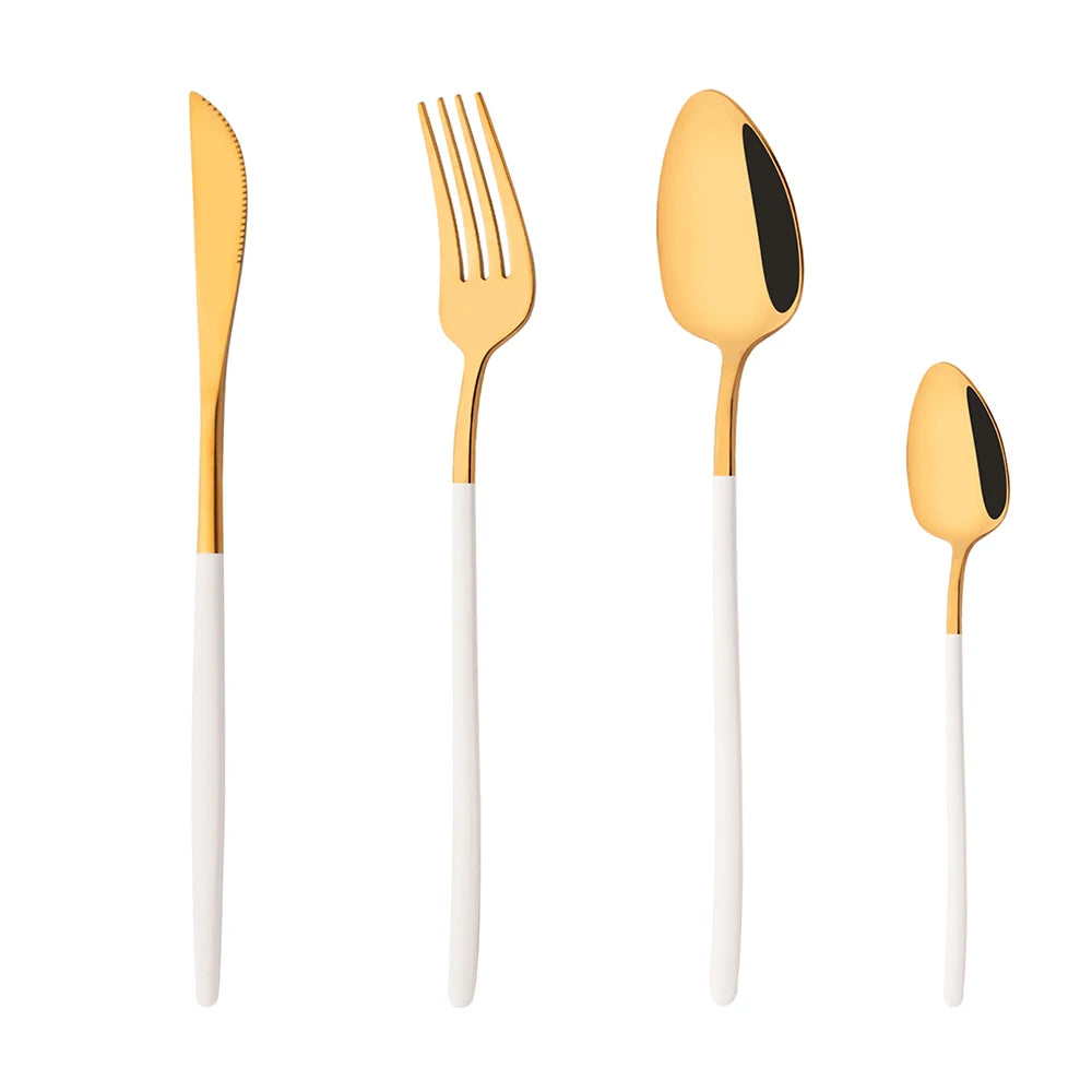 Set of gold cutlery with white handles on a white background