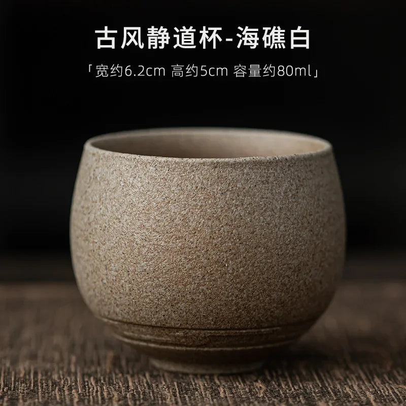 Textured ceramic cup on a wooden surface with dark background