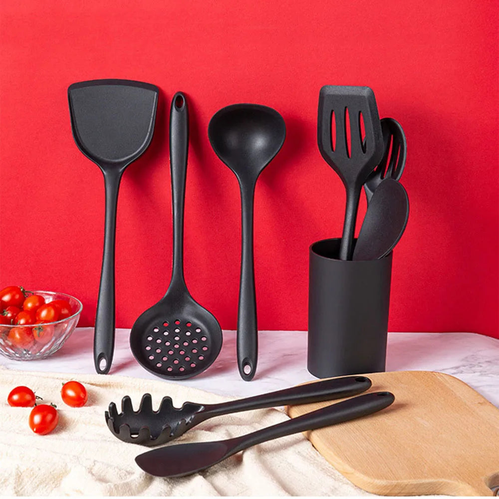 Set of black kitchen utensils on a red background
