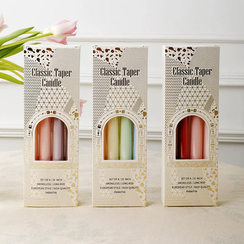 Three boxes of 'Classic Taper Candle' with candles inside on a light background.