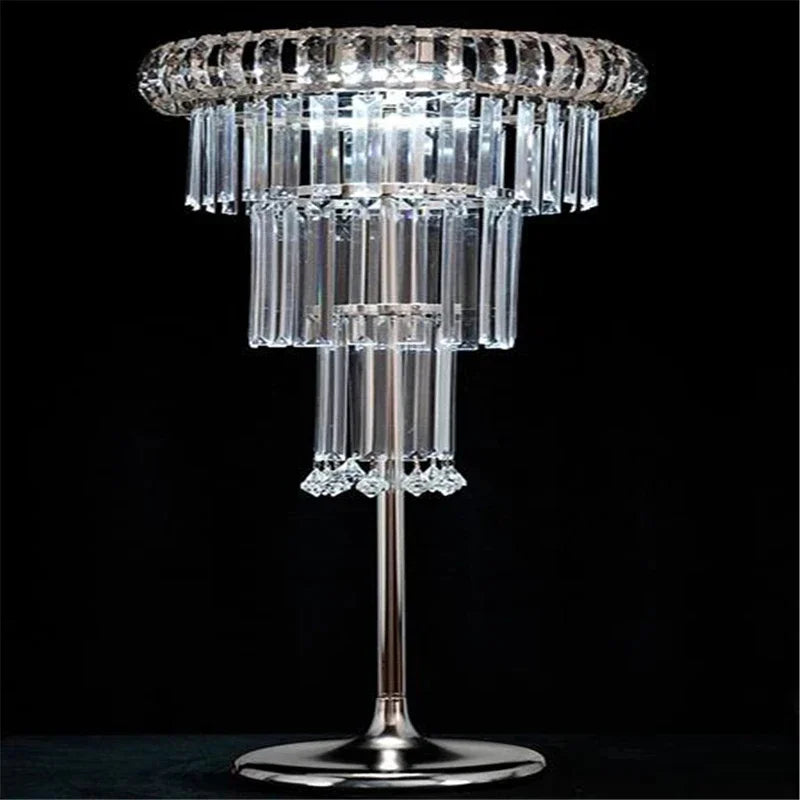 Crystal table lamp with multiple tiers on a black background