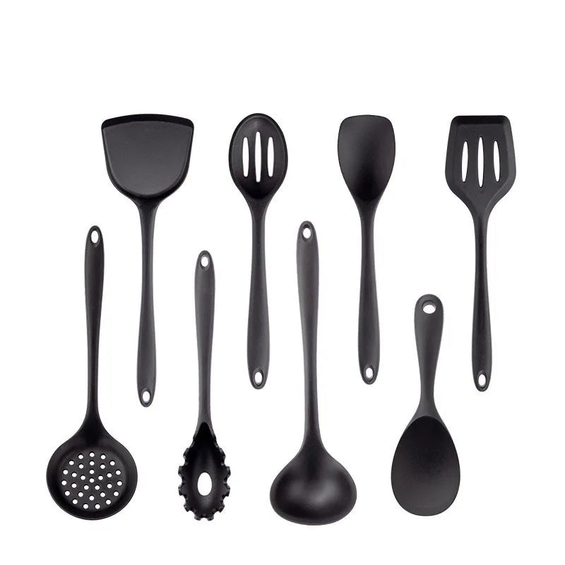 Set of black kitchen utensils including spatulas and ladles on a white background