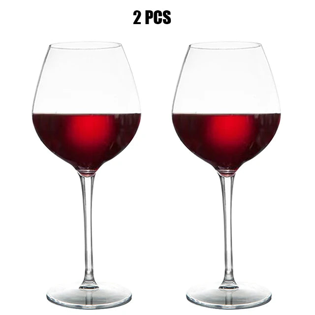 Two wine glasses filled with red wine on a white background