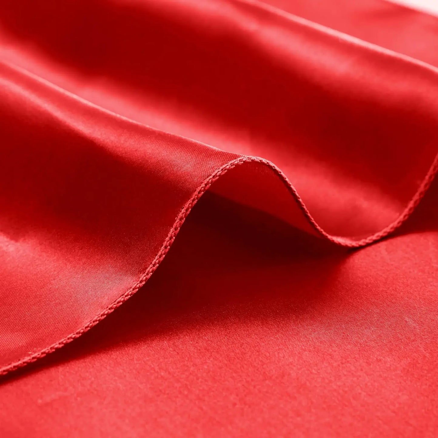Close-up of red fabric with a focus on texture and color.