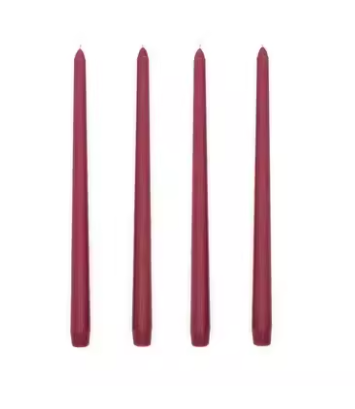 Four purple candles of varying lengths on a white background